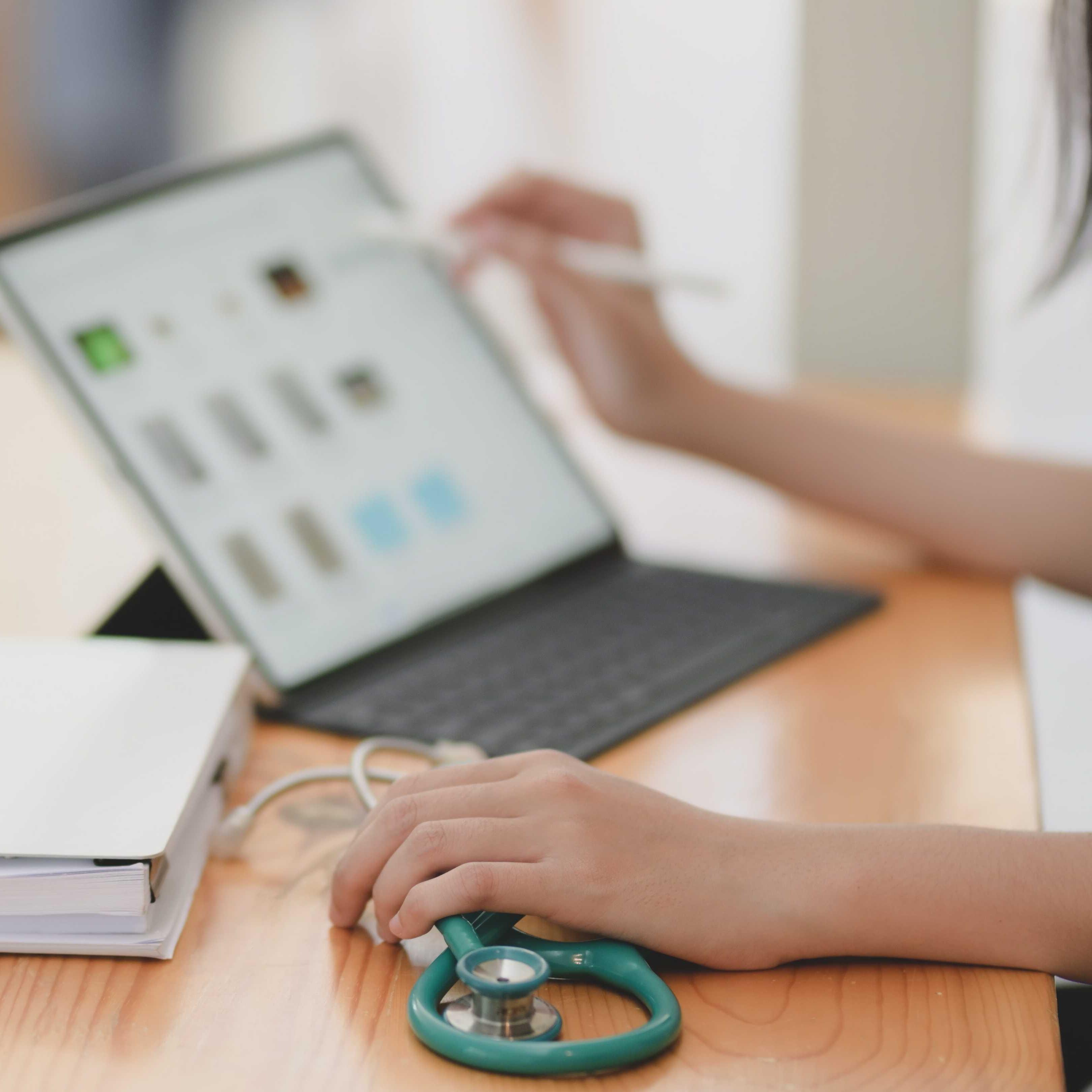 A healthcare worker using a laptop